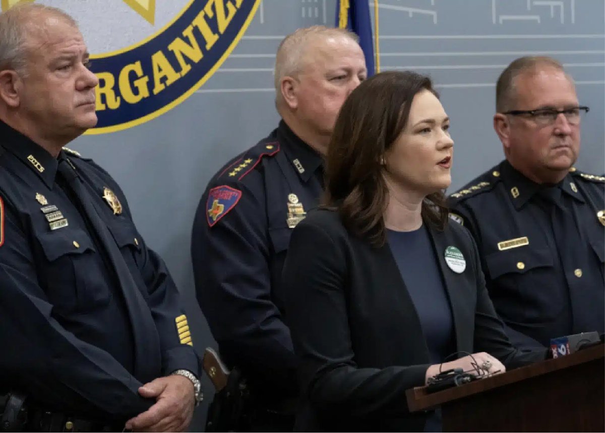 Alex Mealer — campaign photograph at a press event with uniformed officials