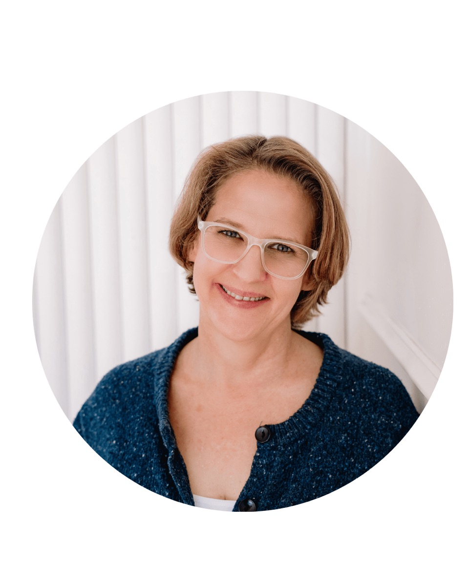 Amy Taylor in glasses and a blue jacket in her official campaign portrait